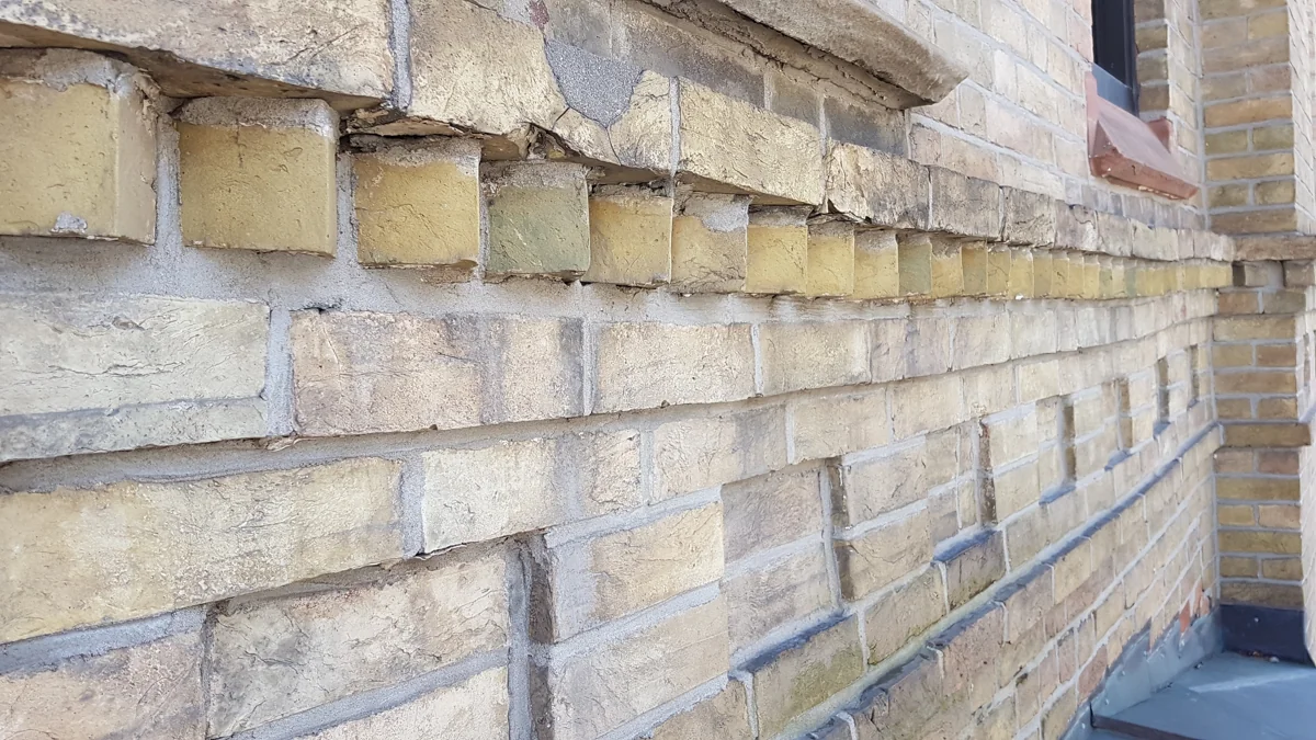 Weathered heritage brickwork with projecting masonry courses