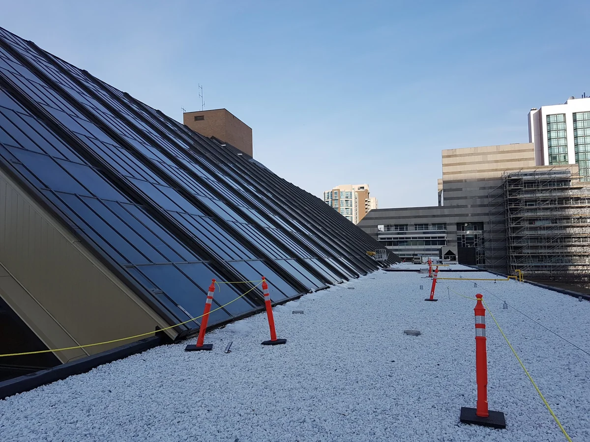 Sloped skylight glazing alongside a rooftop work area